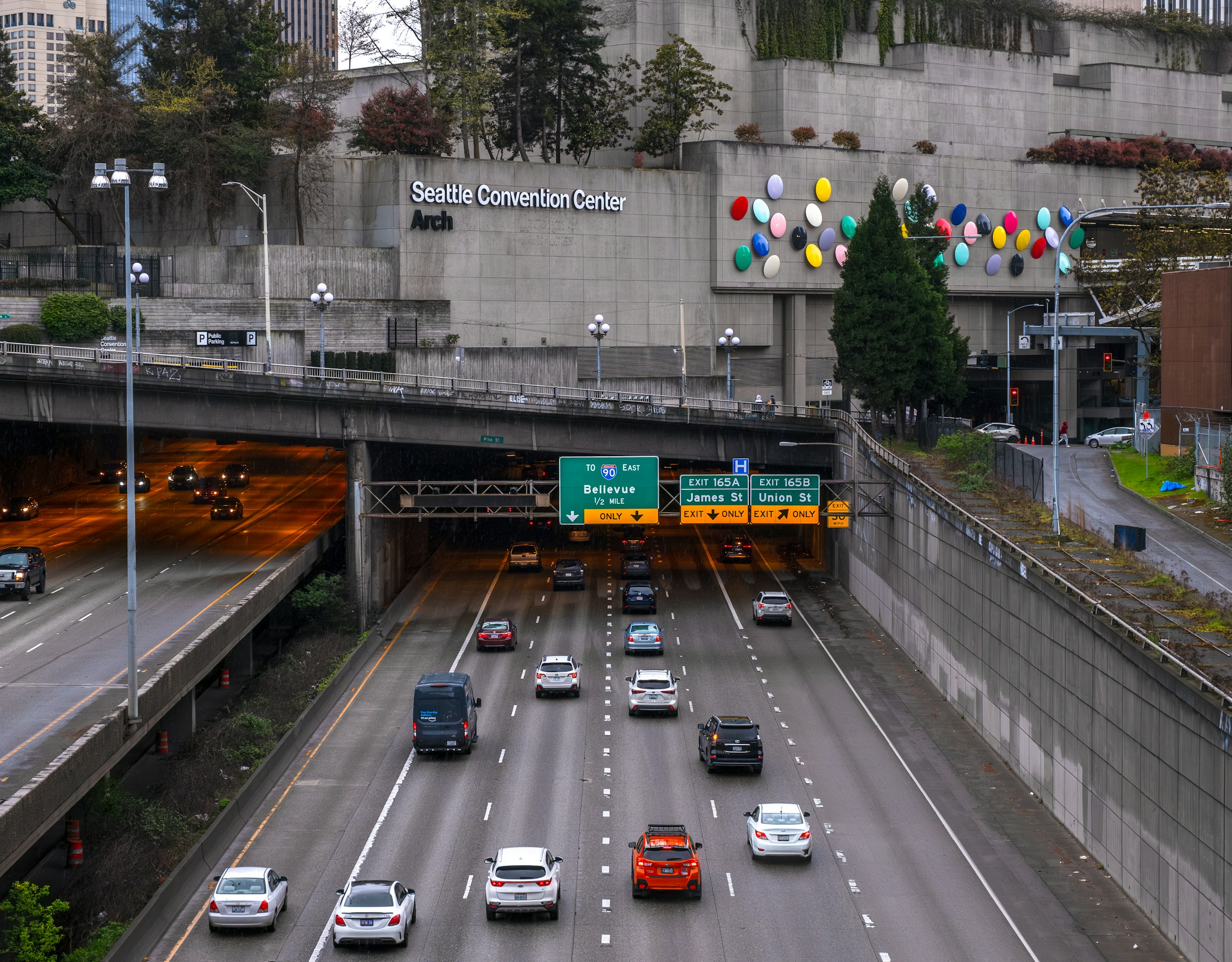 Urban traffic moving beneath a bridge